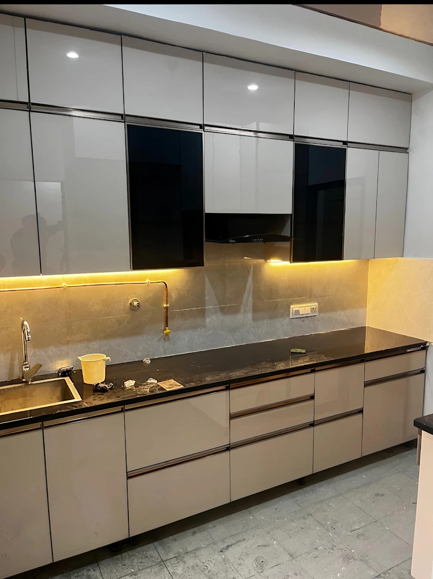 Straight modular kitchen with warm under-cabinet lighting