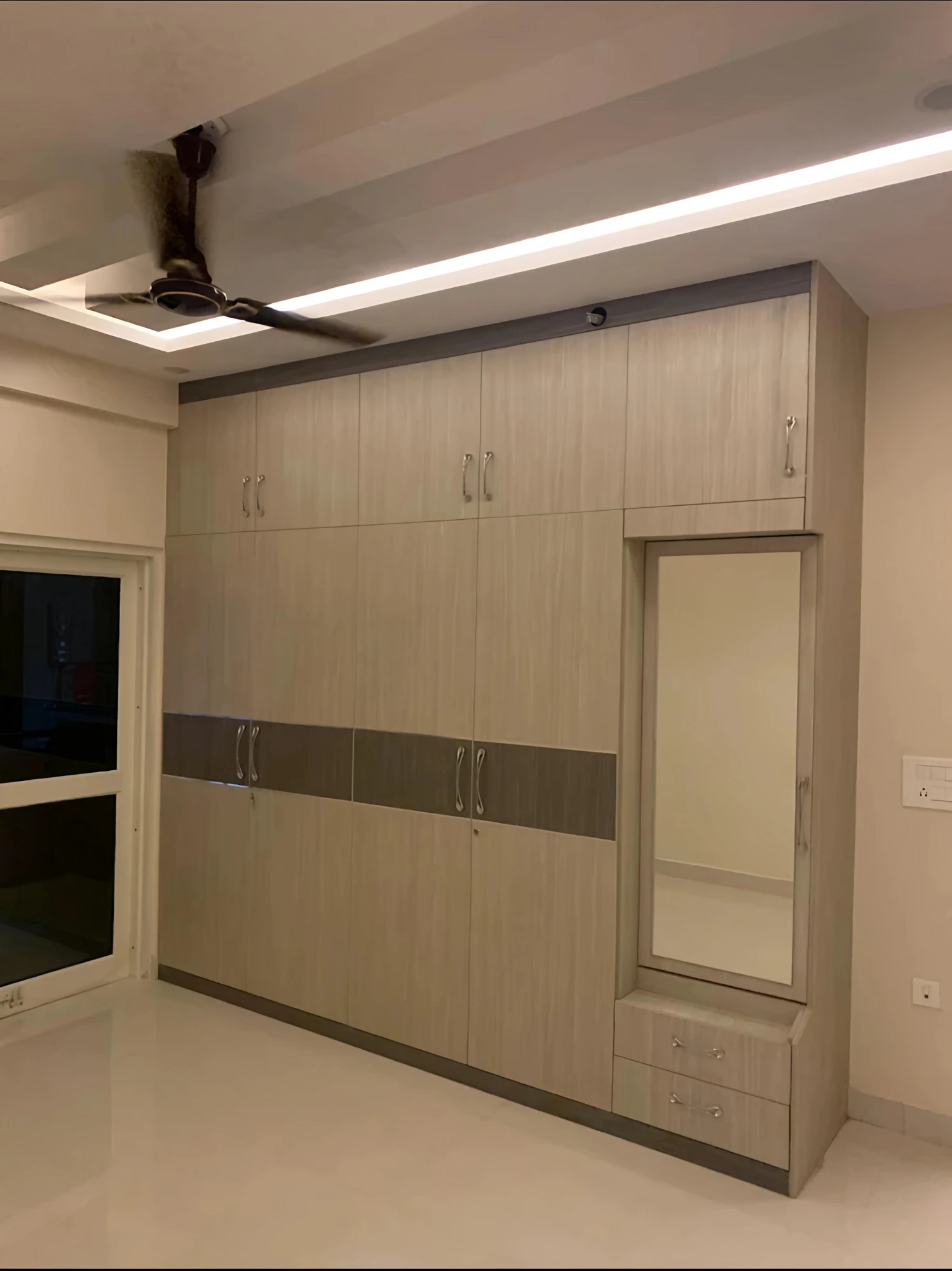 Floor-to-ceiling wardrobe wall with dressing mirror